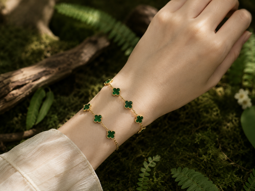 Green jade clover bracelet with five jade clover accents and gold-plated copper chain